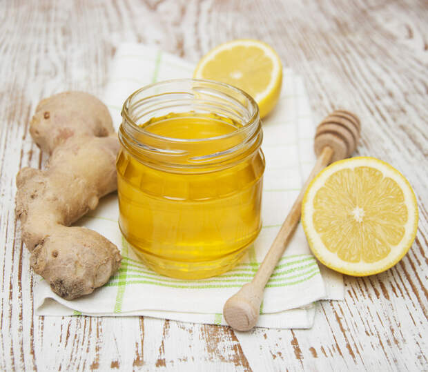 32704468 - honey, lemon and ginger on a wooden background