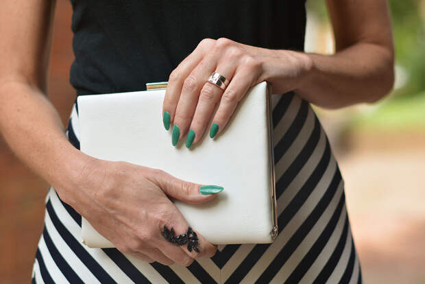 Black and white striped maxi skirt, white box clutch, emerald green mani