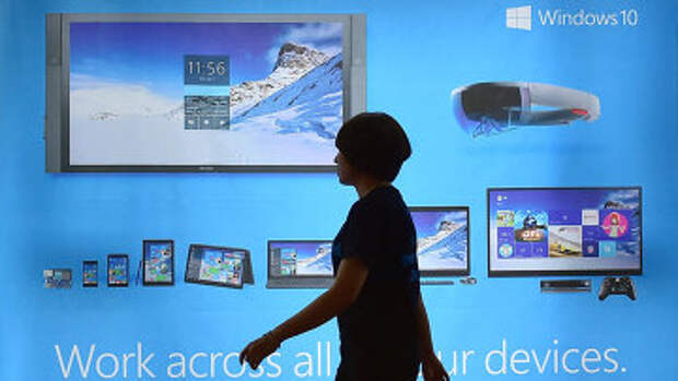 Женщина проходит мимо рекламного щита операционной системы Windows 10 в Сеуле, Южная Корея