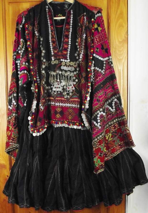 Exceptionally fine Kohistani dress called a jumlo, decorated with silk embroidery, mother of pearl buttons silver coins and amulets.