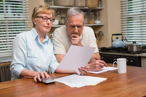 Two people at a table looking at a document.