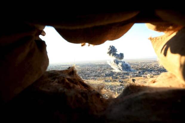 Smoke rises from the site of U.S.-led air strikes in the town of Sinjar