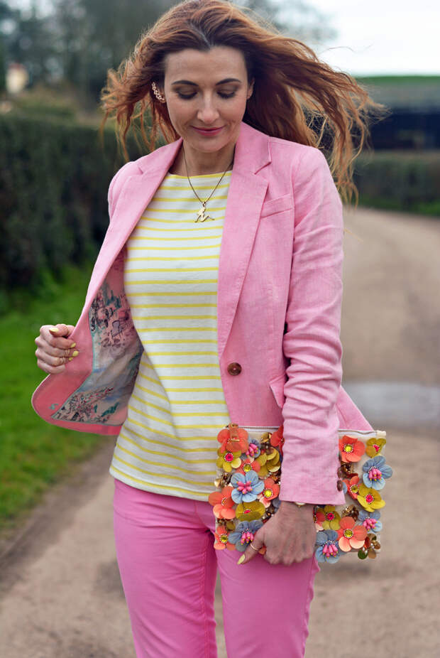 Candy pink blazer, yellow stripe top, pink trousers, floral clutch