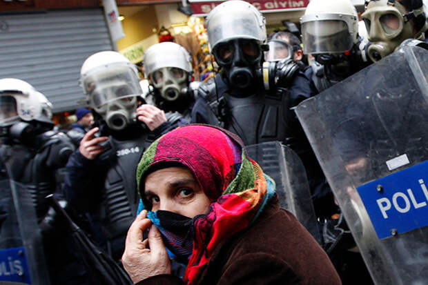 A pro-Kurdish demonstrator covers her face as riot police prevent protestors from marching, at Taksim square in central Istanbul February 15, 2012. Supporters of the pro-Kurdish Peace and Democracy Party (BDP) held a protest to mark the 13th anniversary of the capture of Kurdistan Workers' Party (PKK) leader Abdullah Ocalan. REUTERS/Murad Sezer 