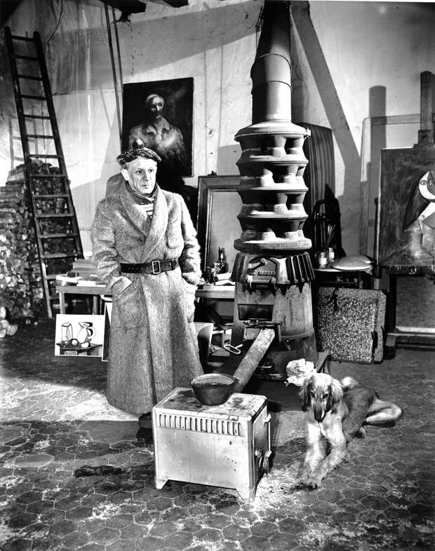 Picasso In Paris Studio, 1944.      Wood stove and Afghan hound.
