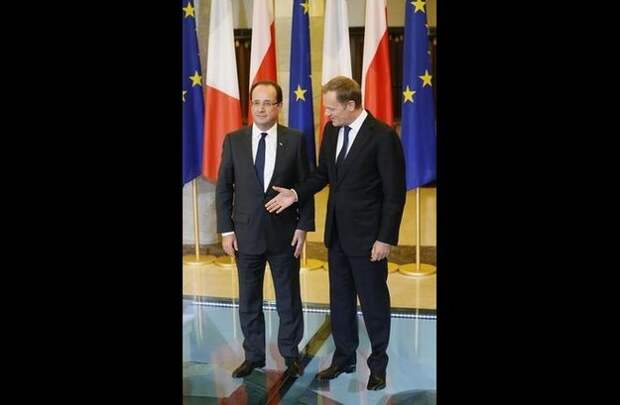 Here he is with Polish Prime Minister Donald Tusk in Warsaw, doing what he does best — not shaking hands.