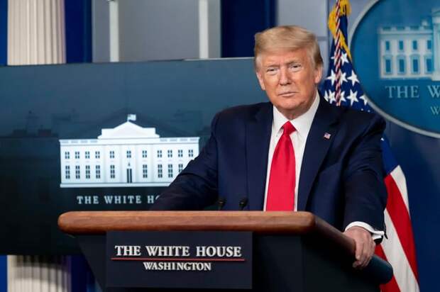 Donald Trump standing before a White House podium.