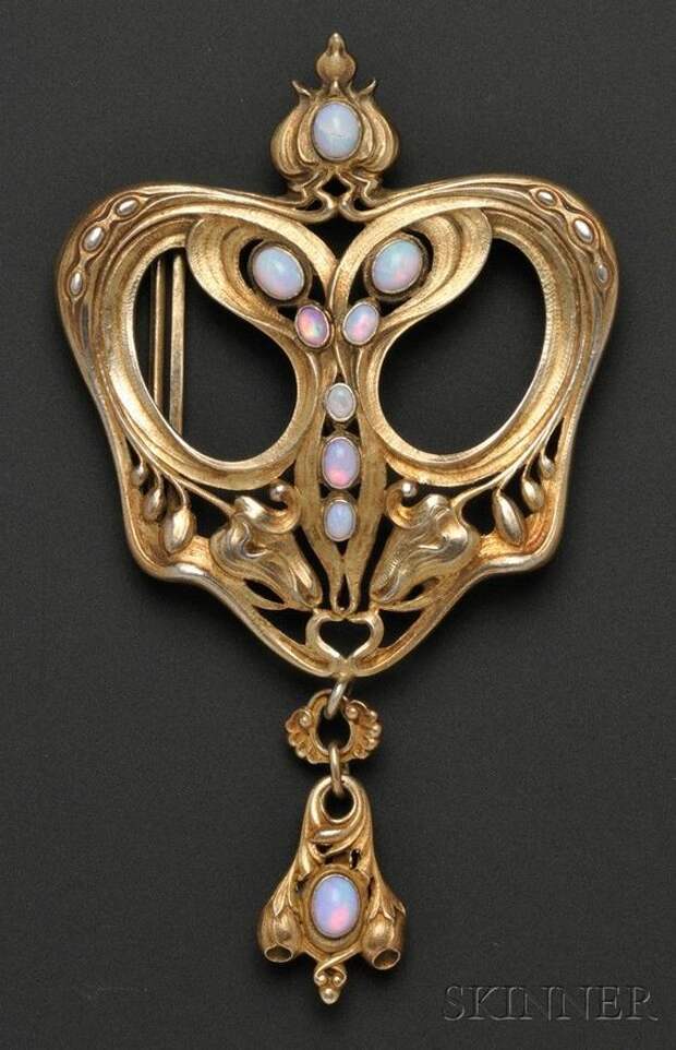Art Nouveau sterling silver-gilt and opal buckle, Gorham, the elaborate scrolling form with bud motifs, bezel-set with opal cabochons, and suspending a drop, 4 1/2 x 2 3/4 in.