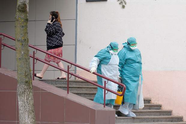 Medical employees wear protective suits as they leave a dormitory as a measure to fight against the coronavirus disease contagion (COVID-19) in Minsk, Belarus March 12