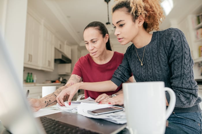 Adults looking at financial paperwork. 