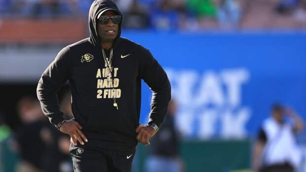 Deion Sanders walks the field before a Colorado football game.