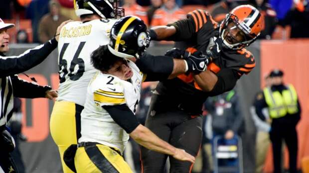 Myles Garrett hits Mason Rudolph across the head with a helmet.