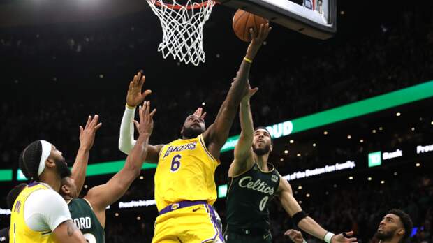 LeBron James lays a ball up.