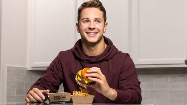 Brock Purdy holding a burger