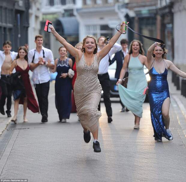 Clutching a can of Desperados tequila, one female reveller looks set to continue the party as she charges through the streets