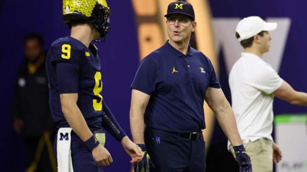 Jim Harbaugh warms up with QB JJ McCarthy before the national title game.