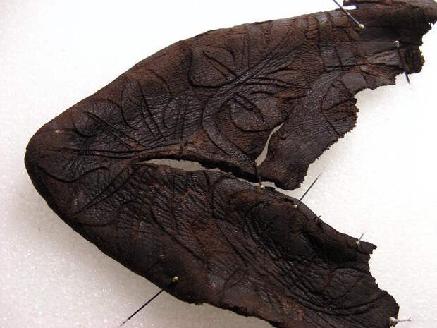 The floral-etched toe of the baby boot.