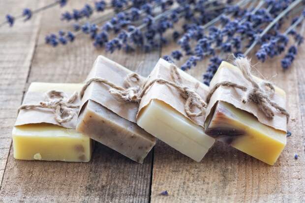 Lavender soap and salt on rustic wooden board. Spa concept