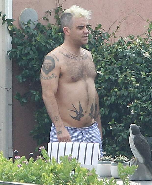 OIC - XCLUSIVEPIX.COM - EXCLUSIVE - MUST AGREE FEES BEFORE USAGE - CALL 077 688 36669 - Robbie Williams seen on holiday on the terrace suite hotel in Rome. His wife Ayda Field went out shopping whilst Robbie kept the children: he changed the nappy for his son Charlton and played with his daughter Theodora Rose. Robbie took off his shorts which showed of his animal underwear on the 6th July 2015. Photo Xclusive Pix 077 688 36669/0203 174 1069