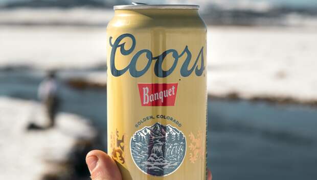 women drinks 50 year old coors banquet