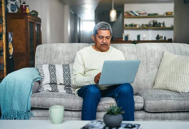 A person on a couch using a laptop.