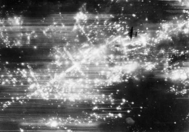 A Lancaster silhouetted against the fires of Hanover on the night of 8-9 October 1943.