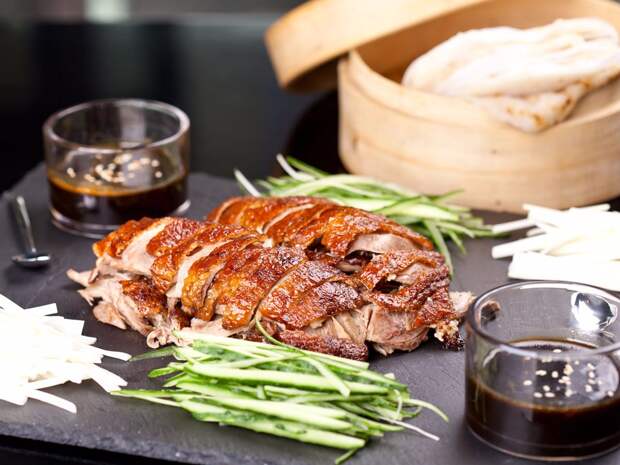 theres-peking-duck-wrapped-in-a-pancake-and-served-with-scallions-and-hoisin-saucejpg