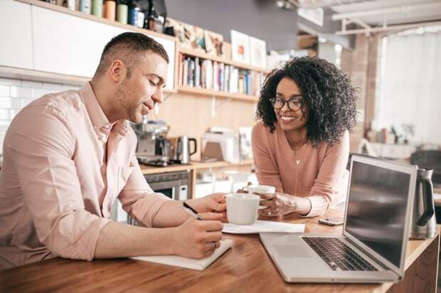A couple go over their personal finances in their kitchen.