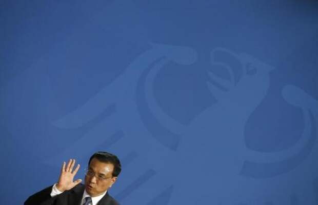 China's Prime Minister Li Keqiang address a news conference following talks with German Chancellor Angela Merkel at the Chancellery in Berlin October 10, 2014. REUTERS/Thomas Peter
