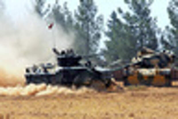 A Turkish army tank and an armored vehicle are stationed near the border with Syria, in Karkamis, Turkey, Tuesday, Aug. 23, 2016. Turkish media reports say Turkish artillery on Tuesday launched new strikes at Islamic State targets across the border in Syria, after two mortar rounds, believed to have been fired by the militants, hit the town of Karkamis, in Turkey's Gaziantep province. Hurriyet newspaper and other reports said the mortar rounds were fired from IS-held Jarablus, Syria.(IHA via AP)