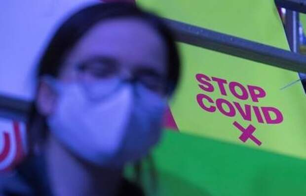 A sign requesting to keep a social distance, amid the coronavirus disease (COVID-19) outbreak, on a seat is pictured as a spectator watches the Proryv (Breakthrough) extreme sports festival in Moscow, Russia December 5, 2020. REUTERS/Shamil Zhumatov