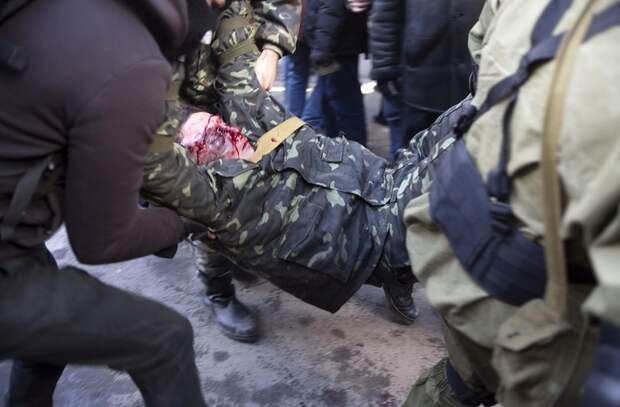 An anti-government protester who was injured during clashes with Interior Ministry members is transported on a stretcher in Kiev