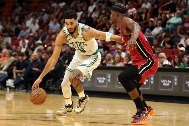 Jayson Tatum drives past Jimmy Butler 