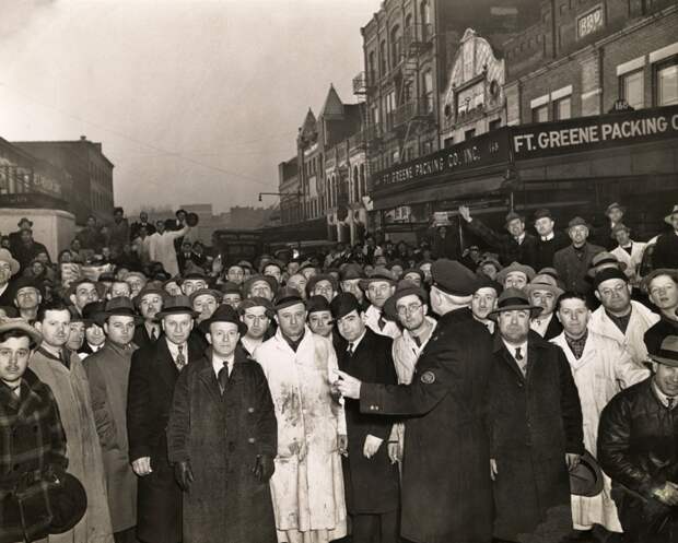 Weegee - Retail butchers lined up at Ft. Greene Market, Brooklyn, in the early dawn, hoping for a little meat to sell from their shops, March 19, 1943